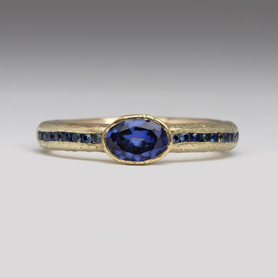9ct Yellow Gold Sandcast Ring with Oval Sapphire & Channel Set Blue Sapphires