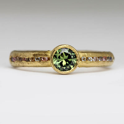 Sandcast 22ct Ring with Green Bezel Set Sapphire & Channel Set Montana Sapphires Half Way around the Band
