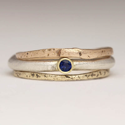 Sandcast 9ct Yellow and Red Gold Stacking Rings and Silver Sandcast Ring with a Sapphire in a Gold Setting